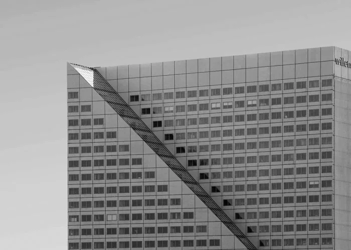 Black-and-white view of a high-rise office building with a diagonal exterior feature.