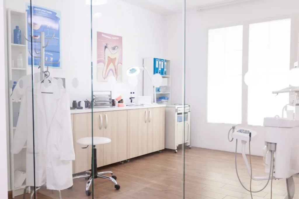 Bright, modern dental treatment room with clinical equipment and cabinetry.