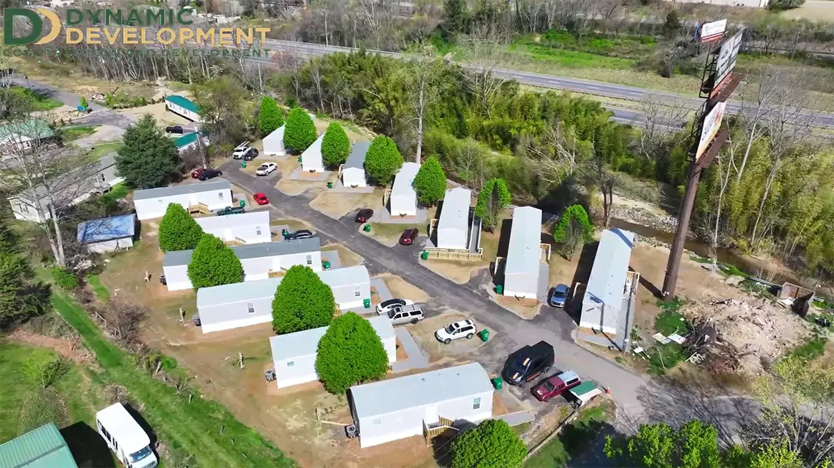 Aerial view of a Western North Carolina neighborhood rebuilt by Dynamic Development after Hurricane Helene, with new homes and paved access roads.